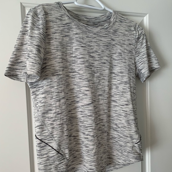 Lululemon size 6 silver anti stink workout top. semi fitted. In good condition.